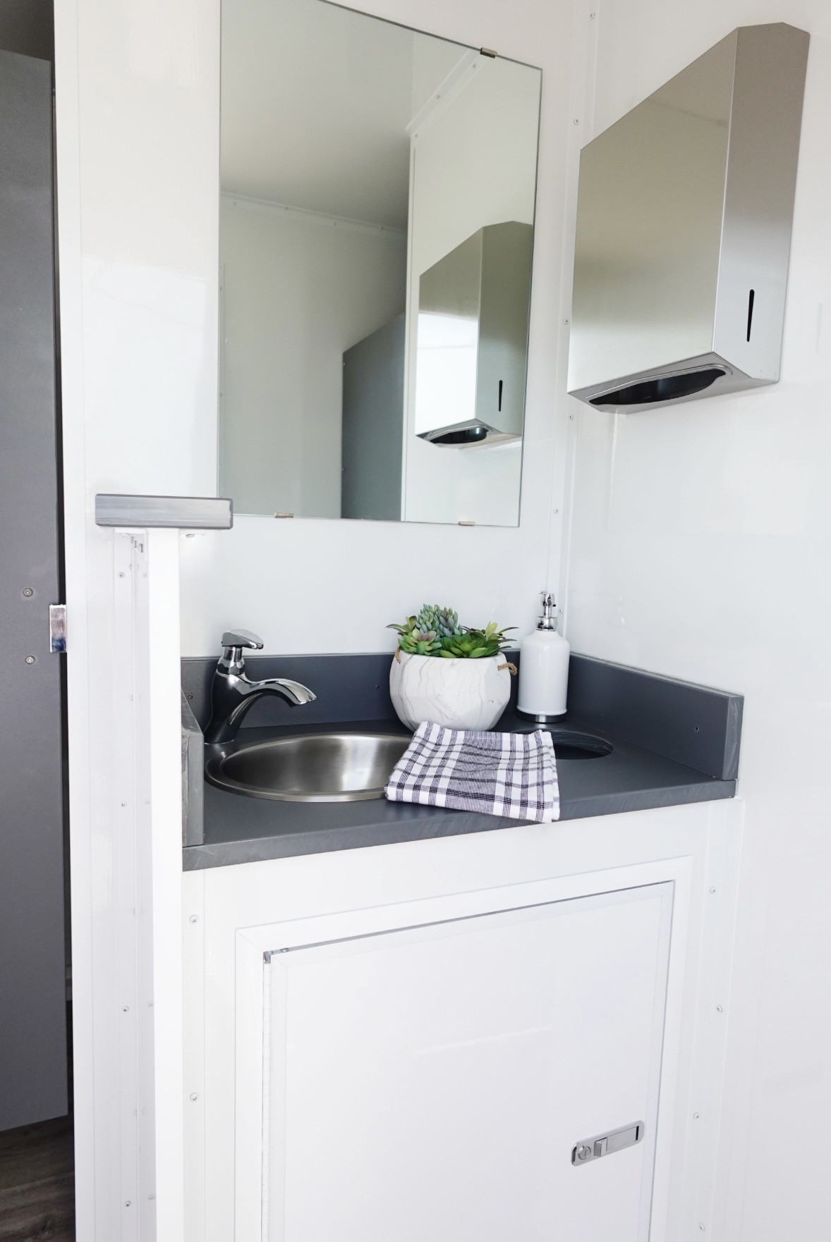 Vortex Trailers restroom trailer interior showing vanity, sink, and mirror