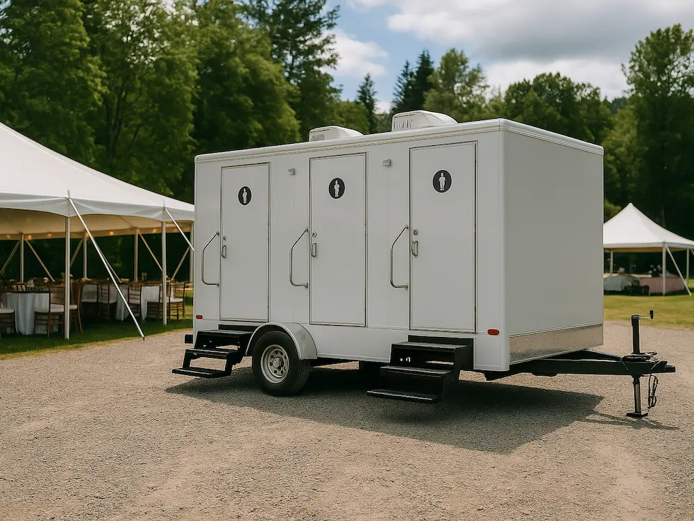 Vortex Trailers restroom trailer set up at an outdoor event with event tents in background